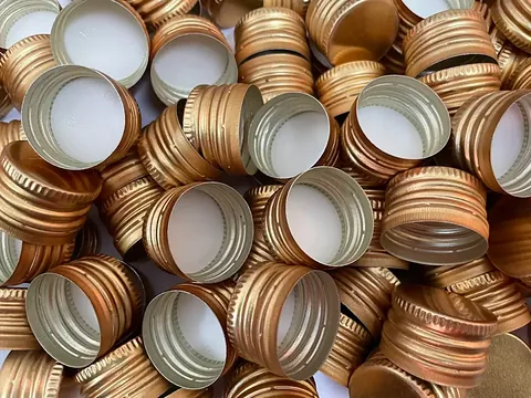 Anodised gold aluminium ROPP pilfer-proof caps made in Chennai by GSR Metal Caps