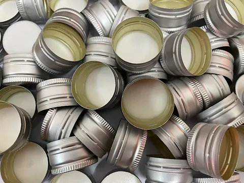 Anodised silver aluminium ROPP caps with knurled skirt, manufactured by GSR Metal Caps